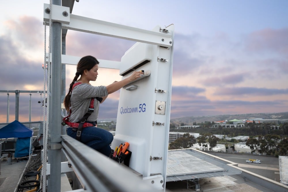 woman who works in 5G on a rooftop working