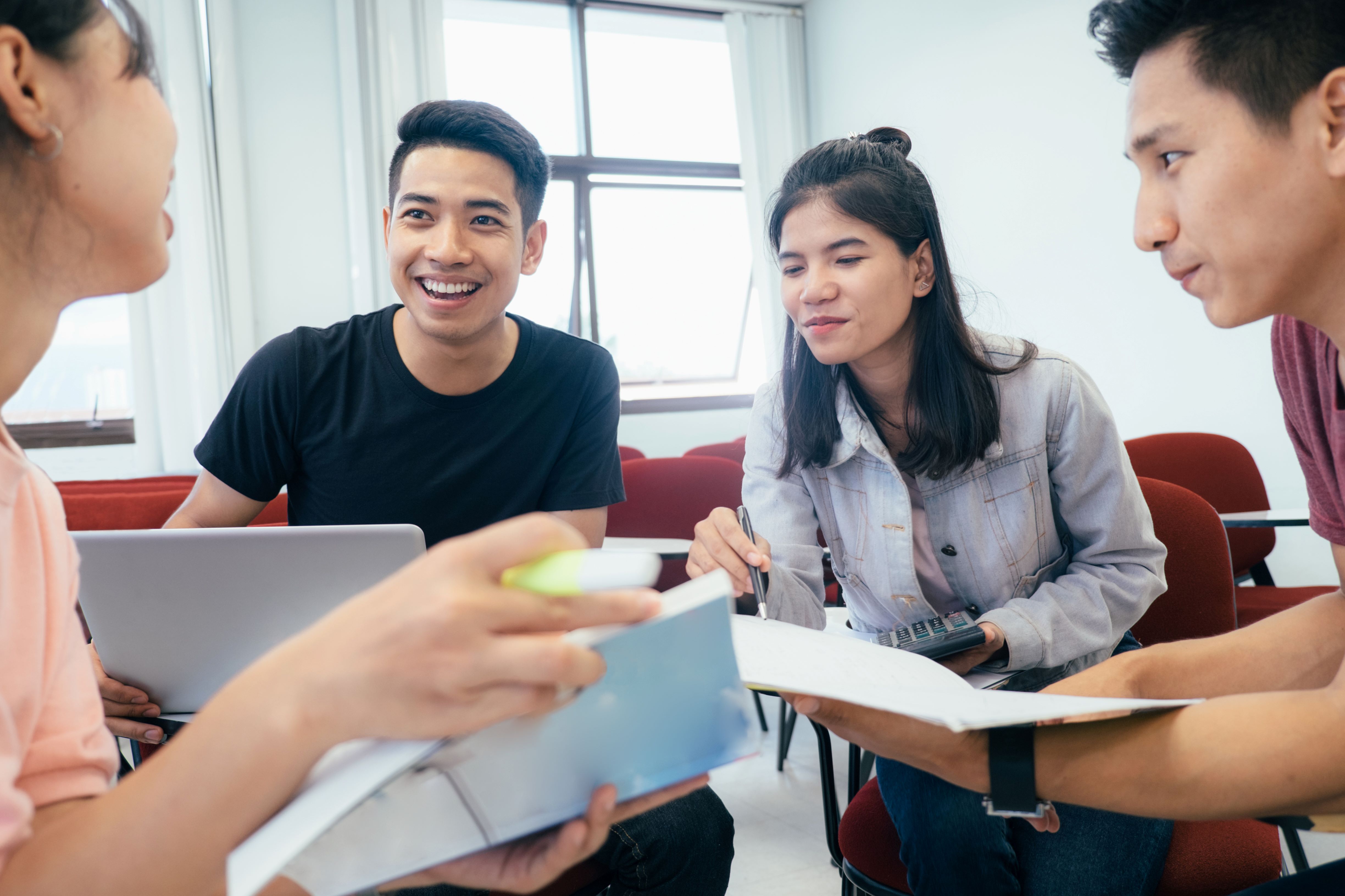 Group laughing while studying 5G