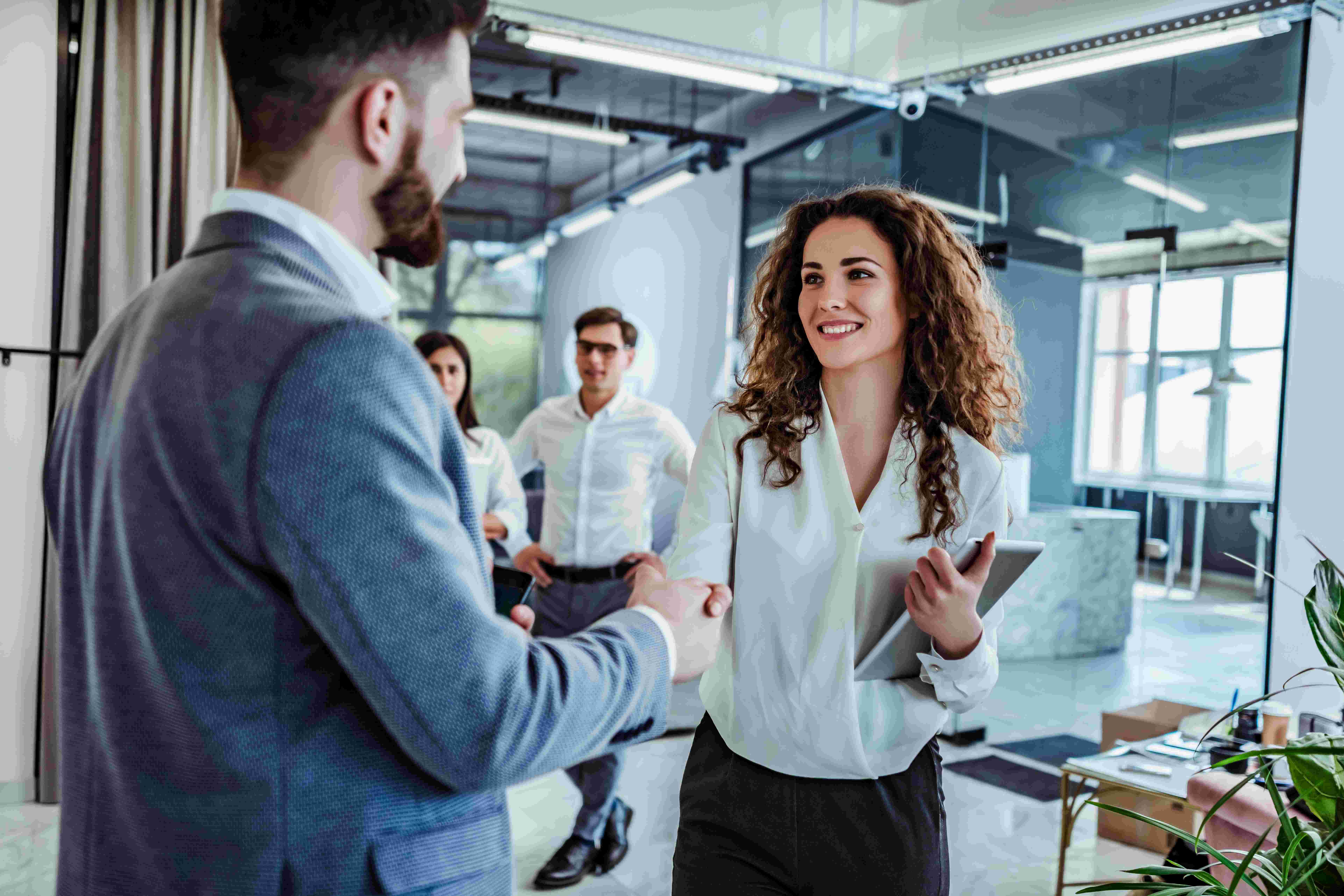 man shaking hands with woman